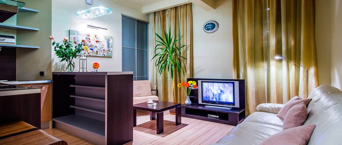 Open-plan kitchen and living room with a dining table and a sofa