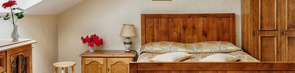 Wide view of the pine mansard bedroom, skylight directly above the bed