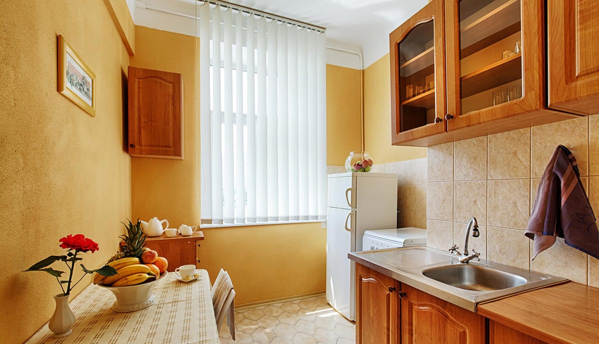 Yellow kitchen with a table of fruit and tea things