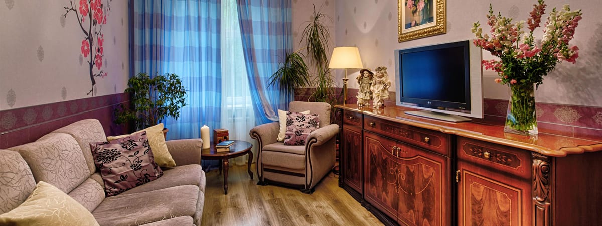 Corner sofa and blue check curtains in the sitting room
